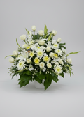 Floral arrangement on a table with plates and glasses in a church setting