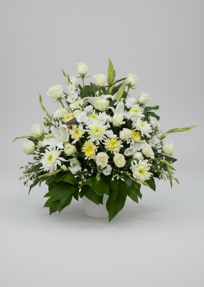 Floral arrangement on a table with plates and glasses in a church setting