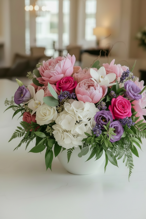 Bouquet of flowers in a white vase on a table with a blurred indoor background