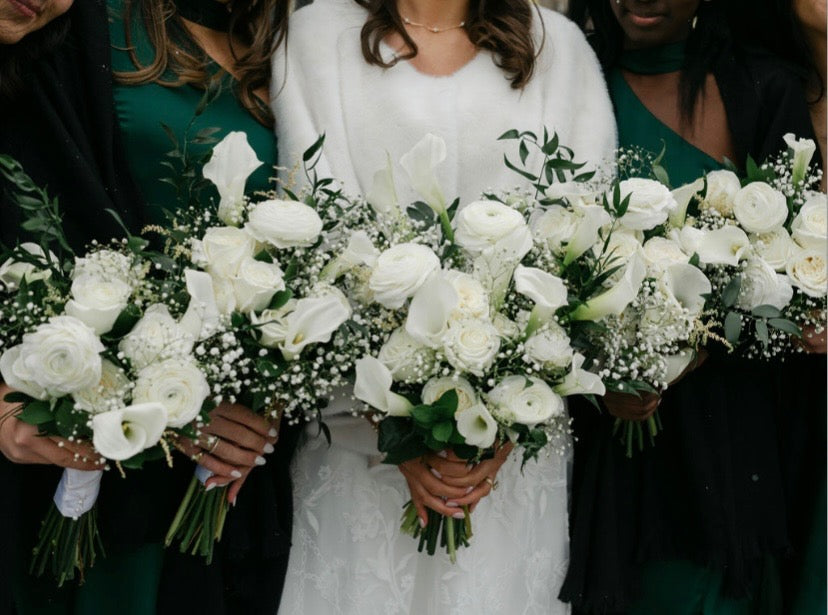 Custom white wedding bouquets with roses, calla lilies and baby's breath by Bloom and Petals
