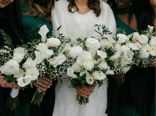 Custom white wedding bouquets with roses, calla lilies and baby's breath by Bloom and Petals